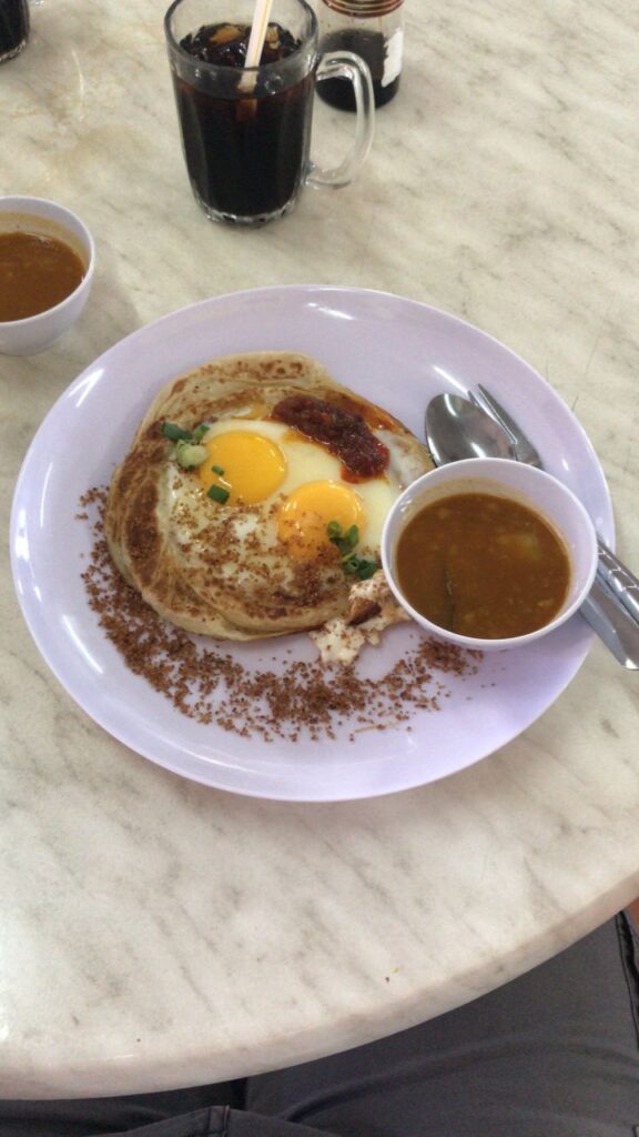 Roti Canai Sarang Burung with sunny side up eggs and sambal at Super Cafe Pending
